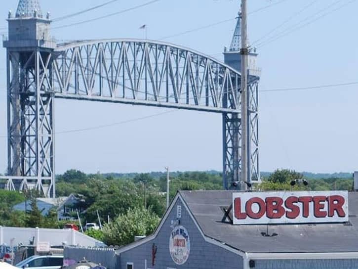 Dog friendly restaurants in bourne include some pretty spectacular views. Here you're seeing the cape cod railroad bridge in the background of East Wind Lobster and Grille at Buzzard's Bay Marina