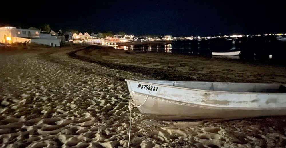 View from the beach of Provincetown harbor at night.